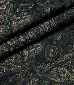 Folded green Keshan tapestry upholstery fabric showcasing the detailed woven texture and vintage Persian-inspired design.