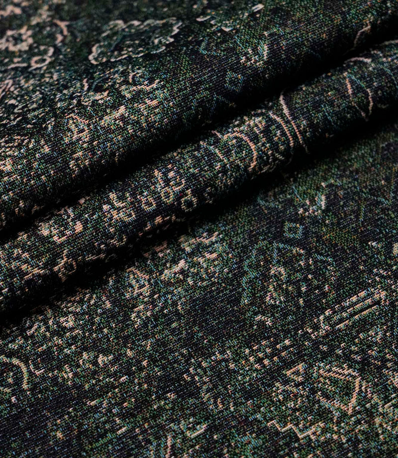 Folded green Keshan tapestry upholstery fabric showcasing the detailed woven texture and vintage Persian-inspired design.