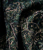 Close-up of green Keshan tapestry upholstery fabric showing the intricate woven texture and antique-inspired Persian motif.