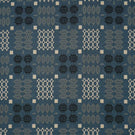 Kinfolk geometric fabric in warm terracotta orange with repeating black, grey and cream woven-style motifs.