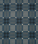 Kinfolk geometric fabric in warm terracotta orange with repeating black, grey and cream woven-style motifs.