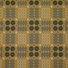 Kinfolk geometric fabric shown flat, with a mustard yellow ground and repeating charcoal, grey and cream woven motifs arranged in a structured pattern.