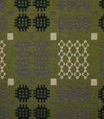 Close-up of Kinfolk fabric showing its textured weave and Scandi-inspired geometric pattern in black, soft grey and cream against an olive green background.