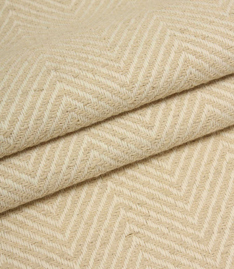Close-up of beige fabric with a herringbone pattern
