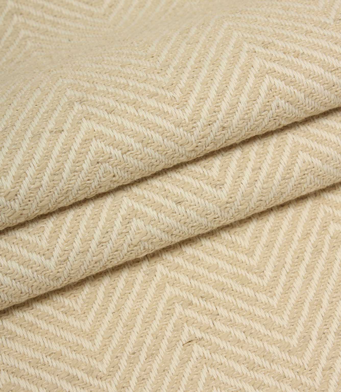 Close-up of beige fabric with a herringbone pattern