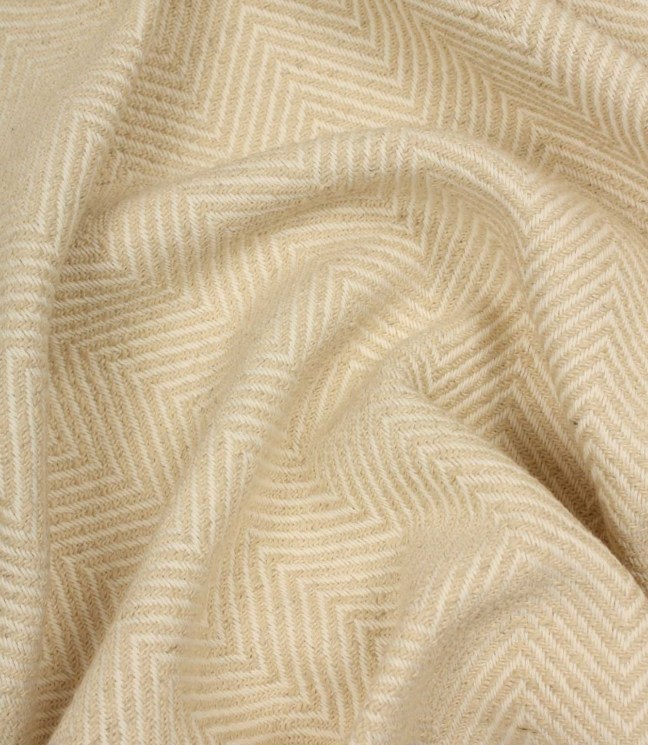 Close-up of beige fabric with a herringbone pattern