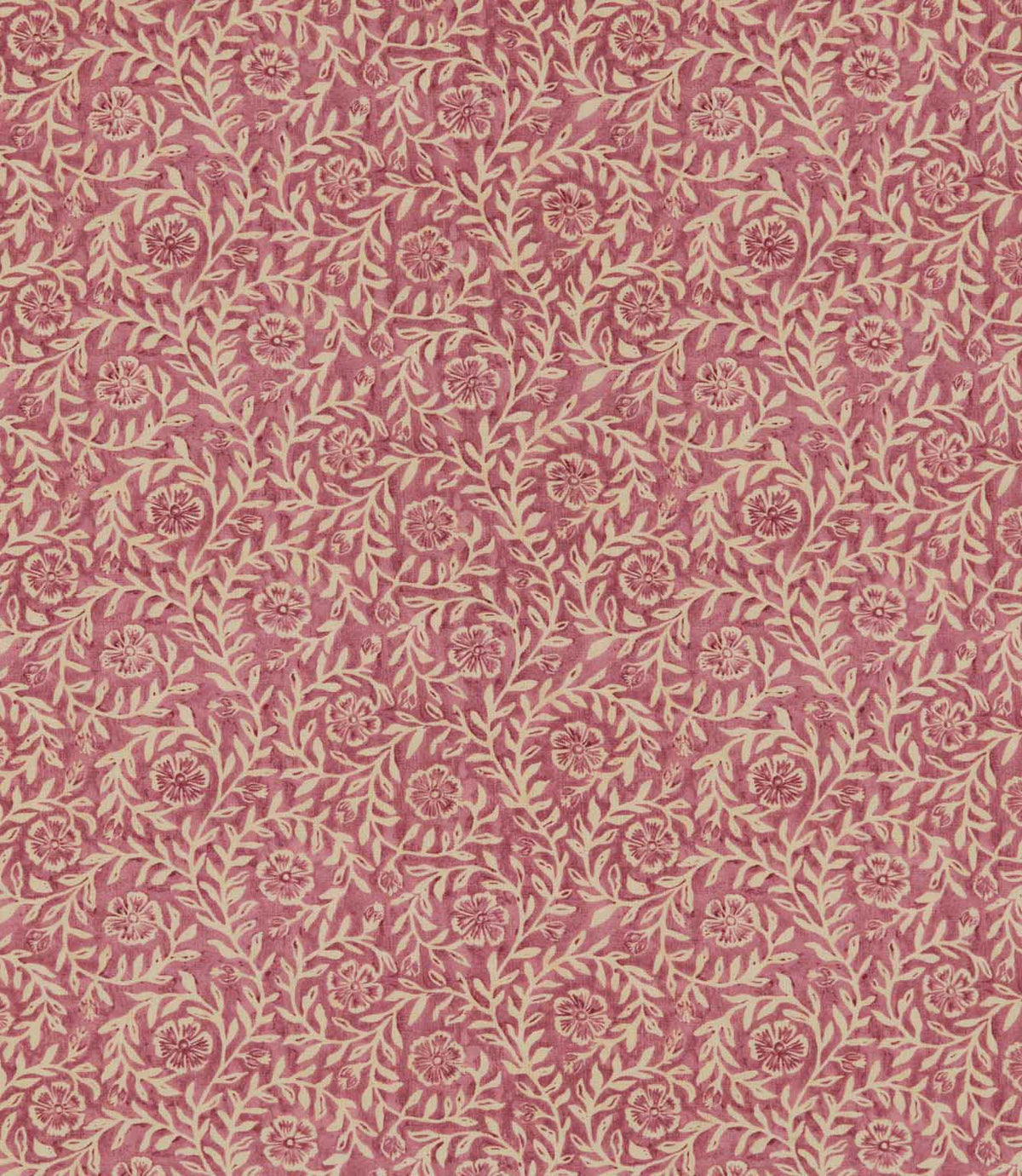 Manorville Rosehip floral fabric featuring a repeating botanical print of delicate cream flowers, trailing leafy branches and winding stems against a warm, dusty rose pink background with subtle tonal texture.