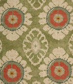 Close-up of olive green floral medallion fabric featuring coral flower motifs, cream petals and soft geometric detailing on a woven natural-look base.