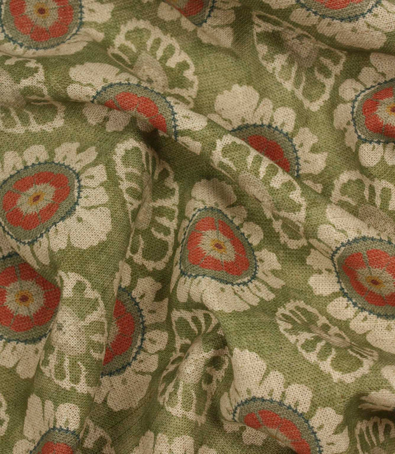 Draped olive green floral upholstery and curtain fabric with repeating coral and cream medallion motifs.