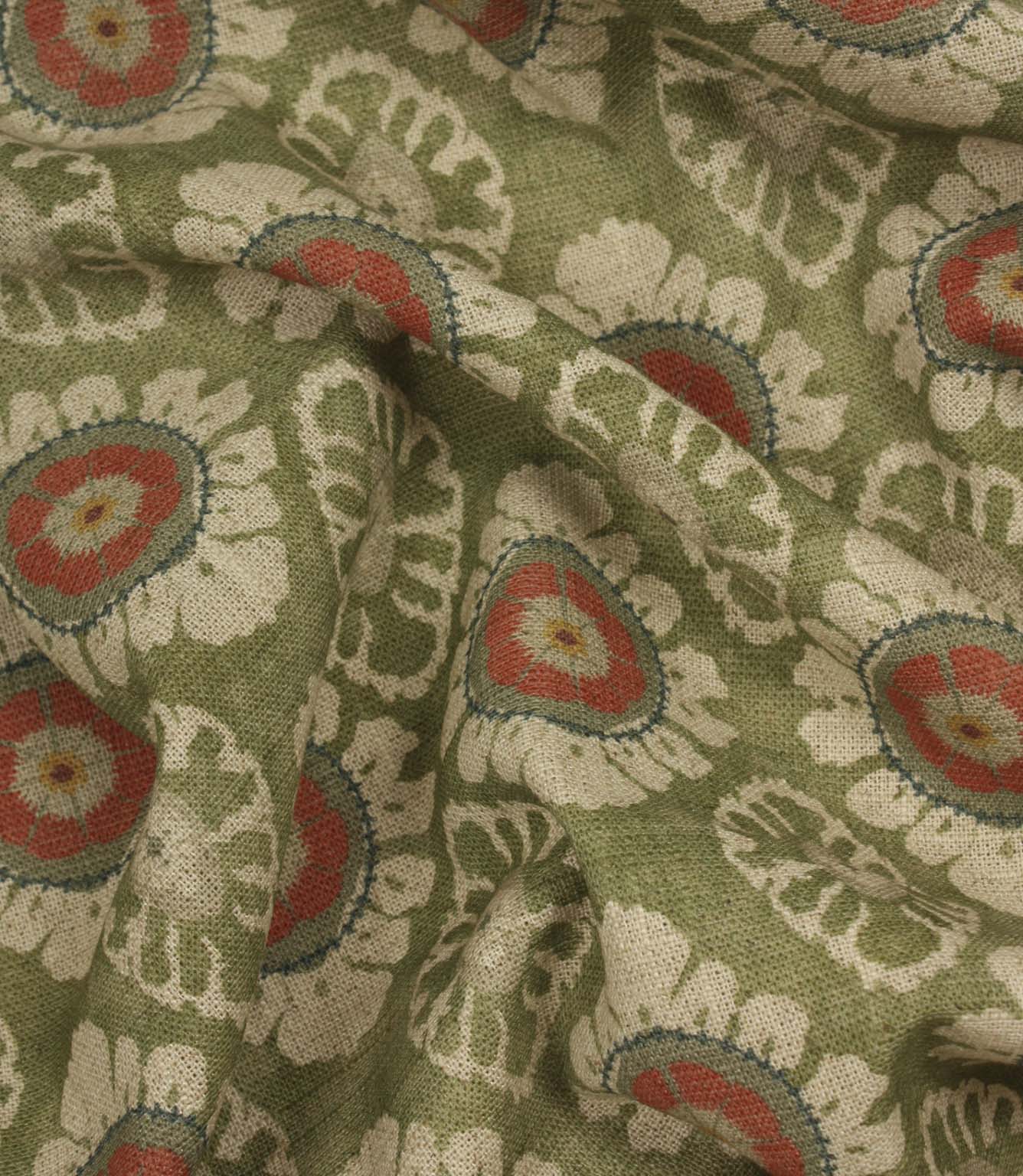 Draped olive green floral upholstery and curtain fabric with repeating coral and cream medallion motifs.