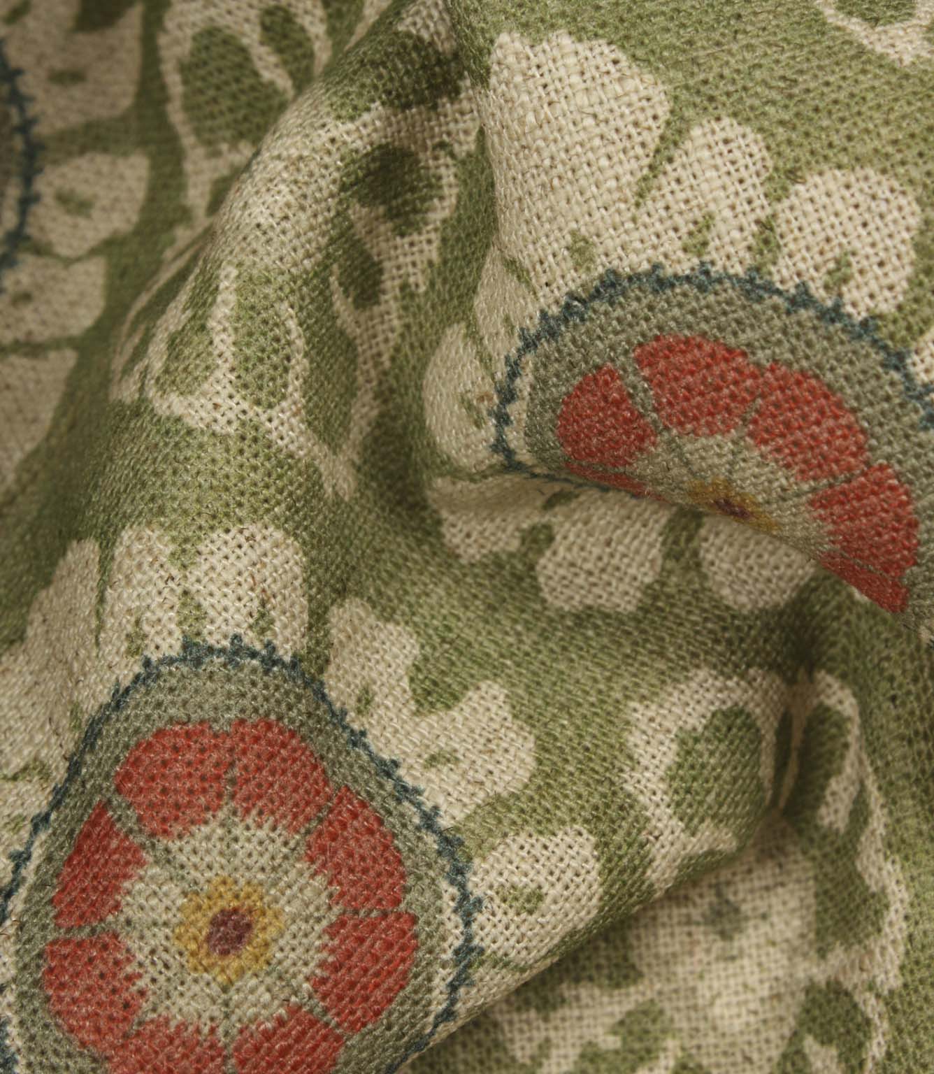Detailed close-up of woven floral fabric in olive green, cream and coral tones, highlighting the textured linen-look finish.