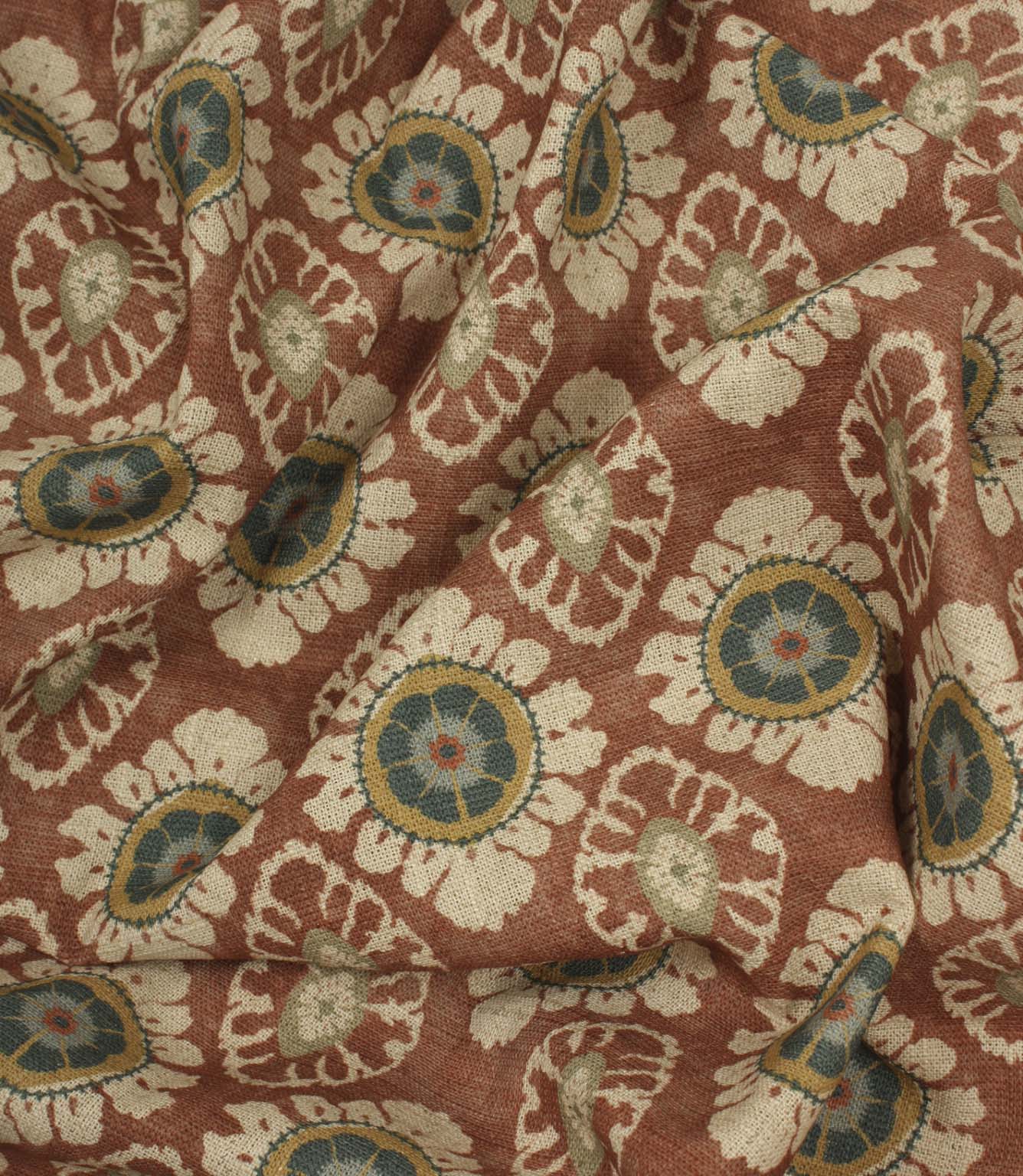 Draped terracotta floral fabric with soft natural texture and traditional decorative pattern.