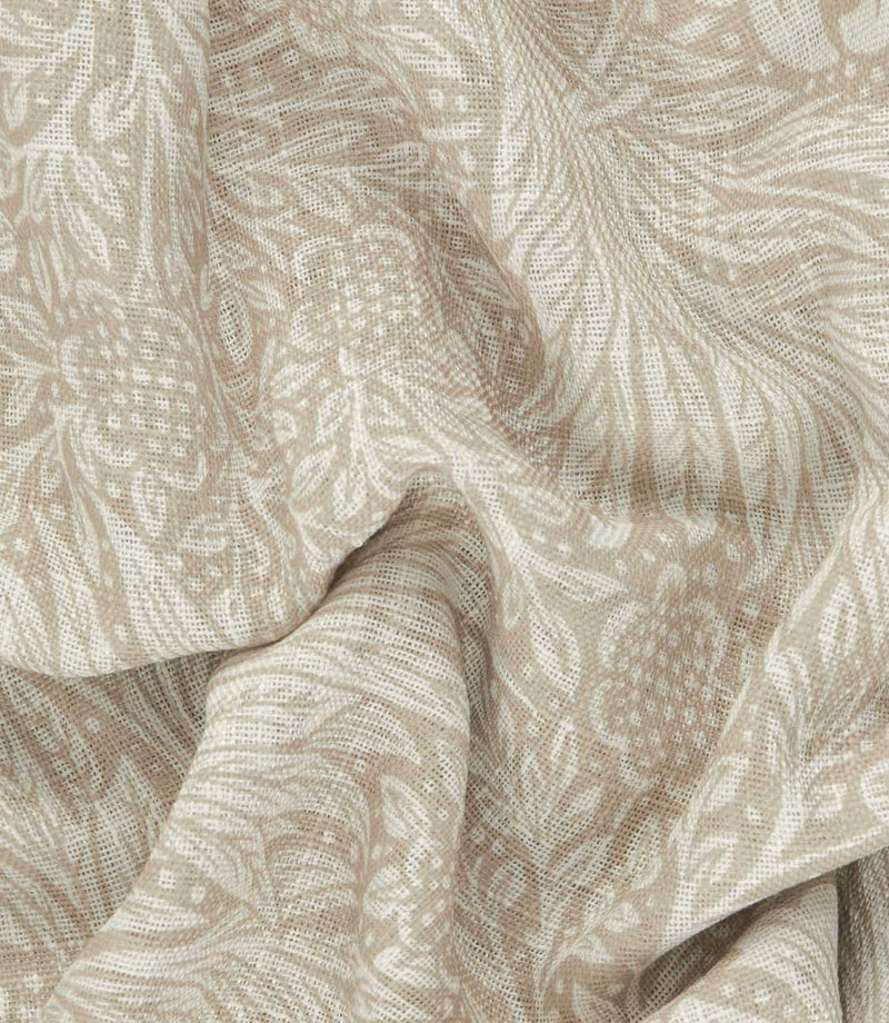 Close-up of Morris & Co Marigold sheer fabric in cream and linen beige, showing the lightweight open weave and intricate William Morris floral pattern.
