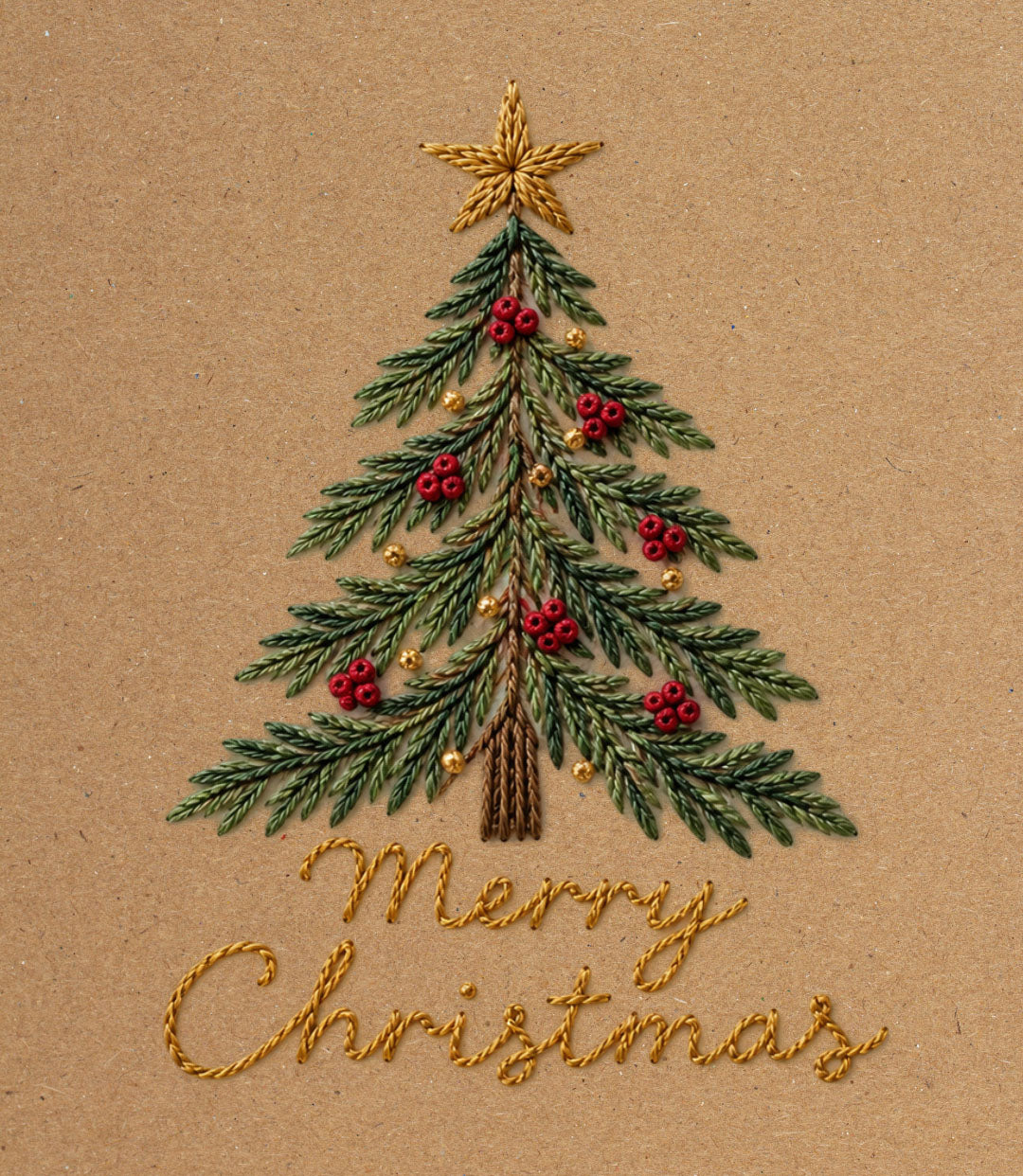 An embroidered Christmas tree on a kraft paper background, decorated with green needles, red berries, gold ornaments, and a gold star, with the words 'Merry Christmas' stitched below in gold.