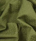 Nessa woven fabric draped in soft folds, displaying the dimensional woven pattern in a green shade.