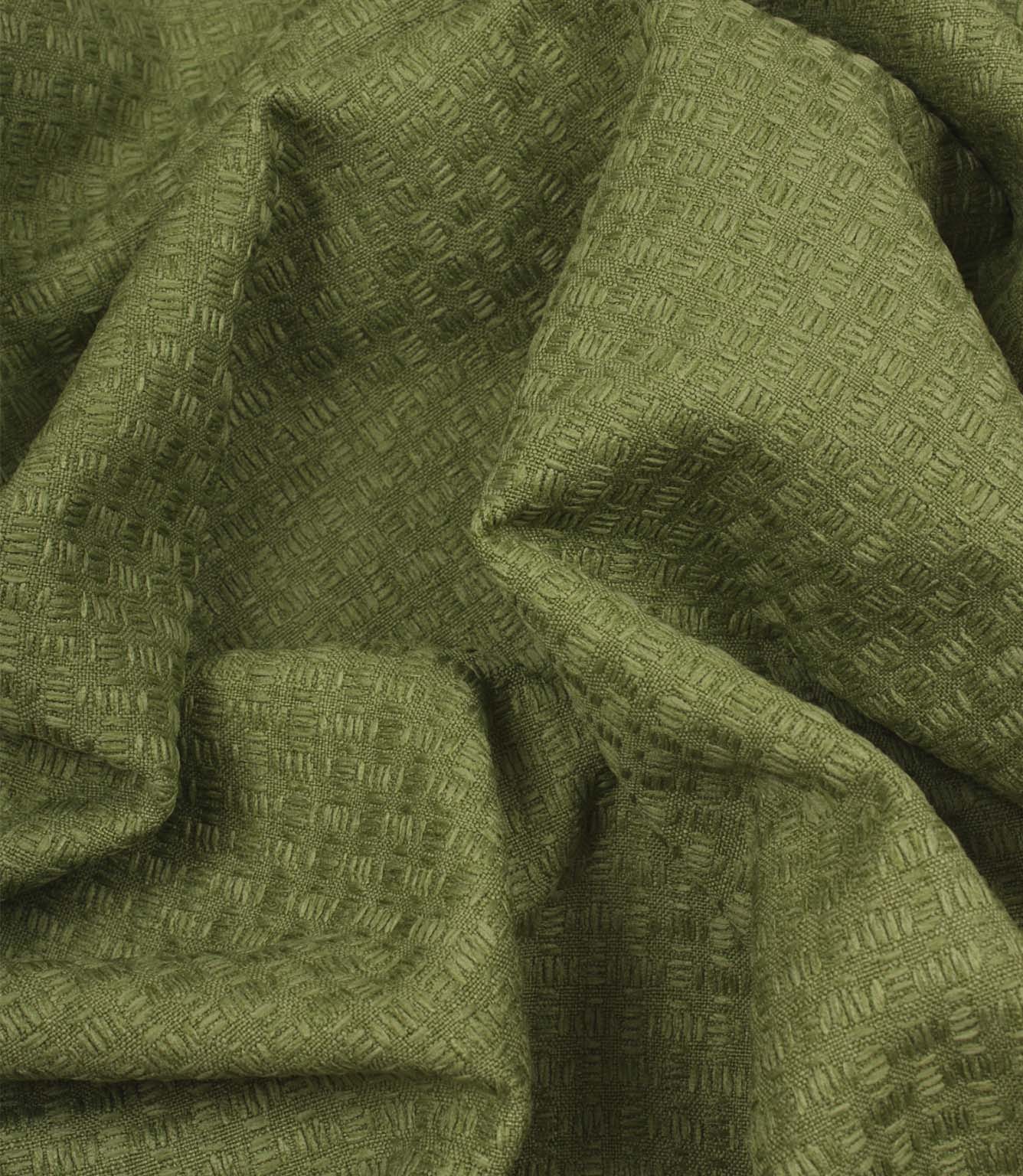 Nessa woven fabric draped in soft folds, displaying the dimensional woven pattern in a green shade.
