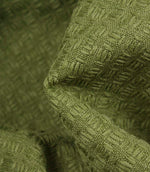 Close-up detail of Nessa geometric woven fabric in green, highlighting the tactile texture and raised woven effect.