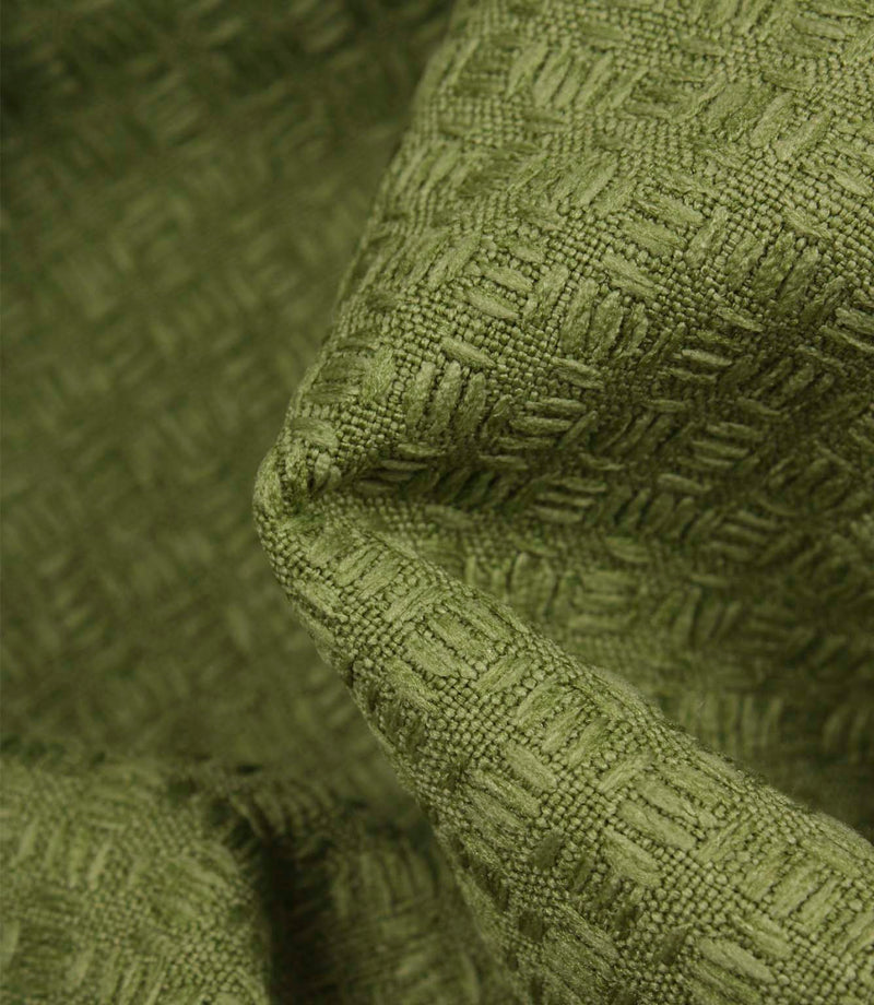 Close-up detail of Nessa geometric woven fabric in green, highlighting the tactile texture and raised woven effect.