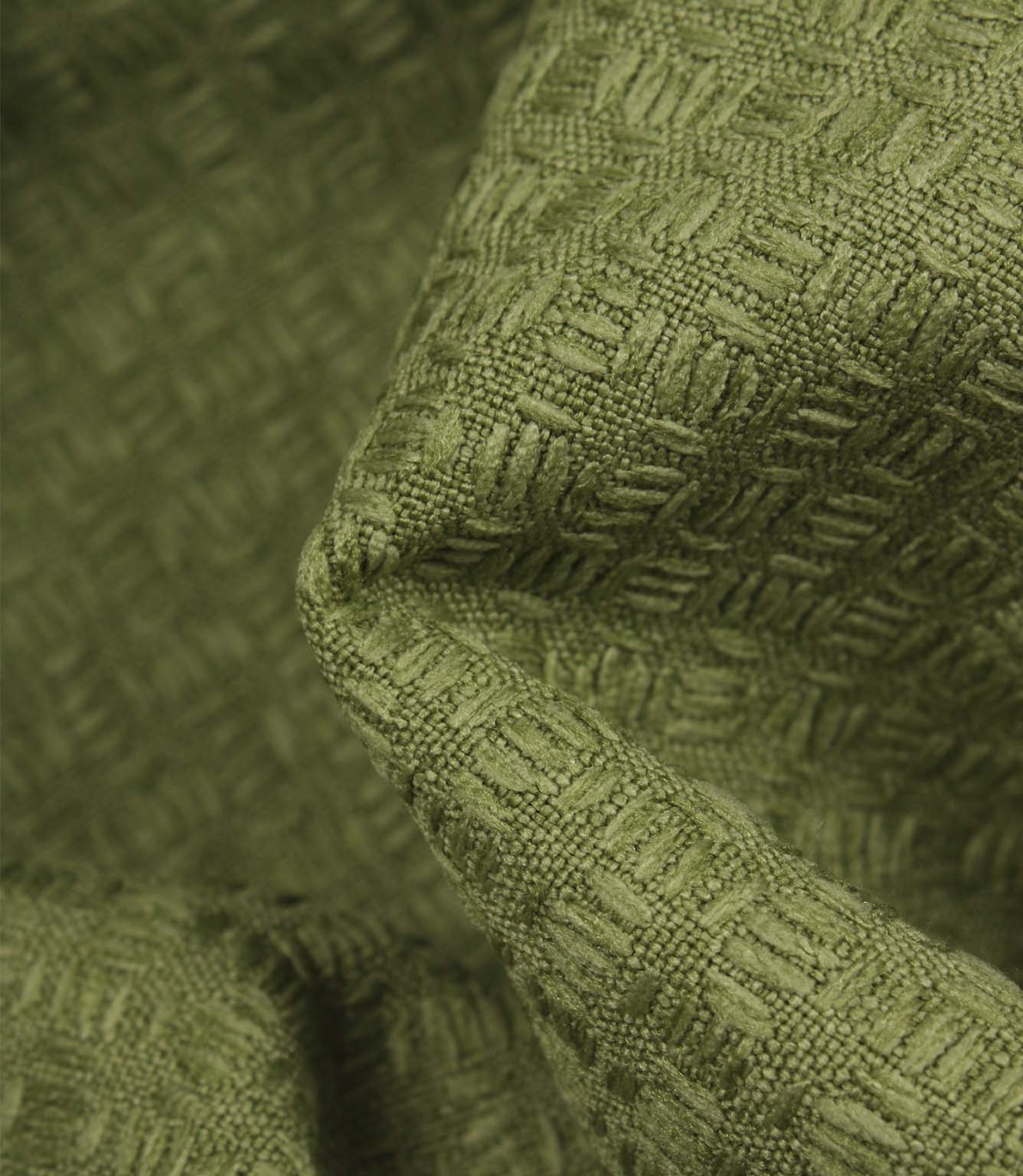 Close-up detail of Nessa geometric woven fabric in green, highlighting the tactile texture and raised woven effect.