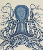 Close-up of blue octopus fabric featuring finely detailed tentacles and shaded illustration work on a soft ivory base cloth.