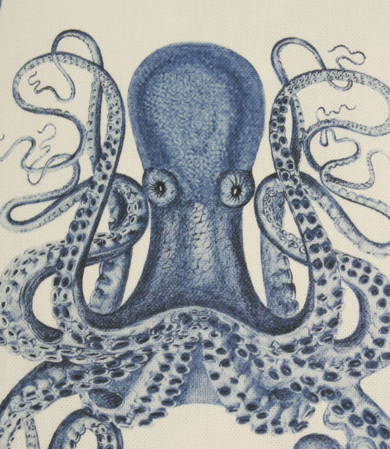 Close-up of blue octopus fabric featuring finely detailed tentacles and shaded illustration work on a soft ivory base cloth.