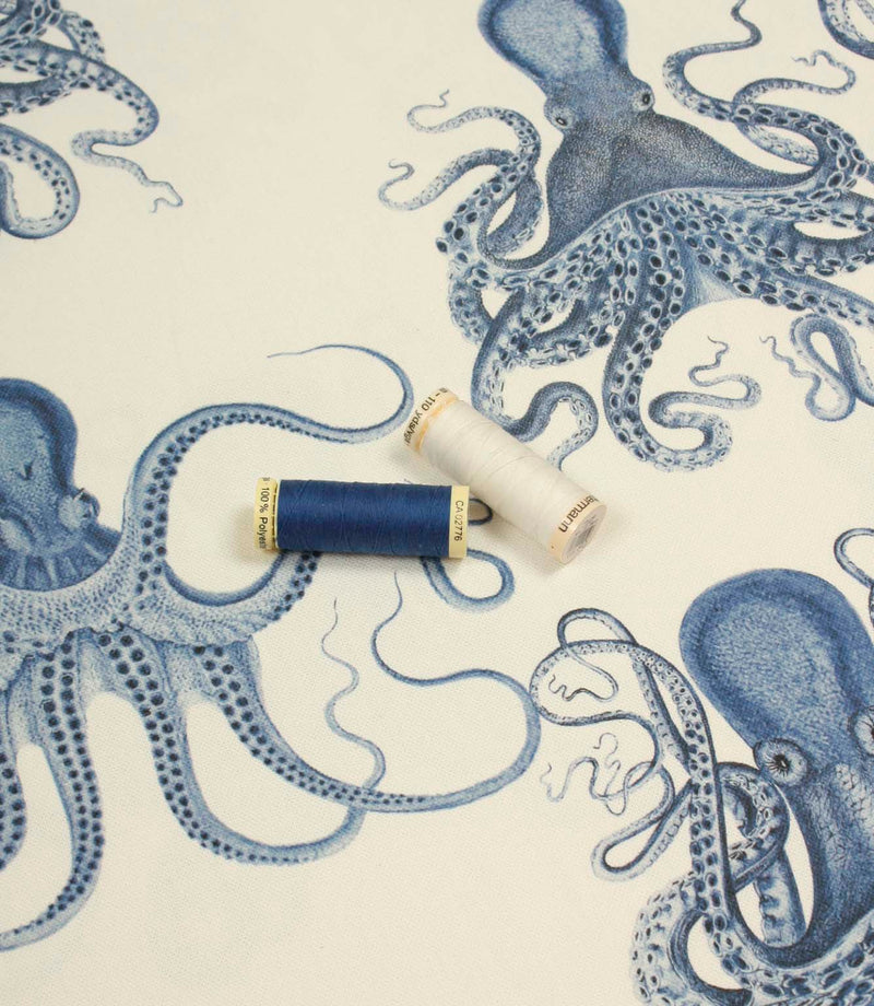 Marine-inspired octopus print fabric styled with coordinating blue and white sewing threads to highlight colour tones and detail.