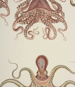 Fabric with orange octopus pattern on a cream background