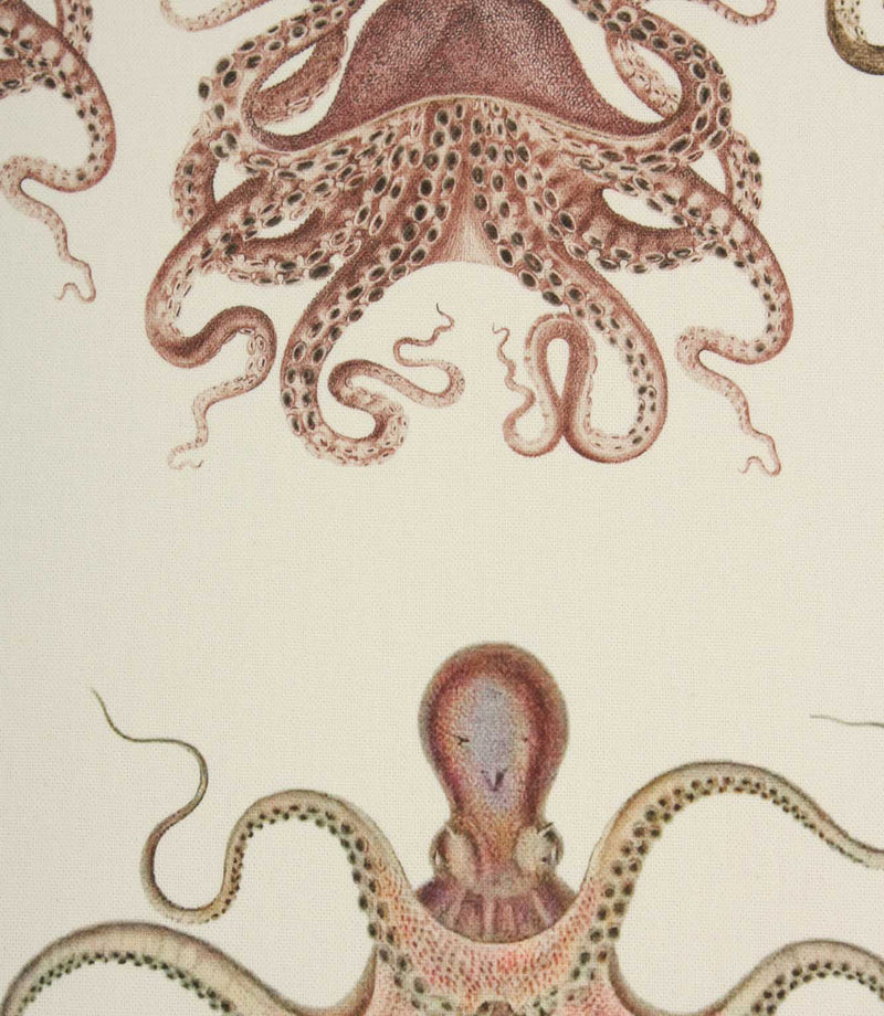 Fabric with orange octopus pattern on a cream background