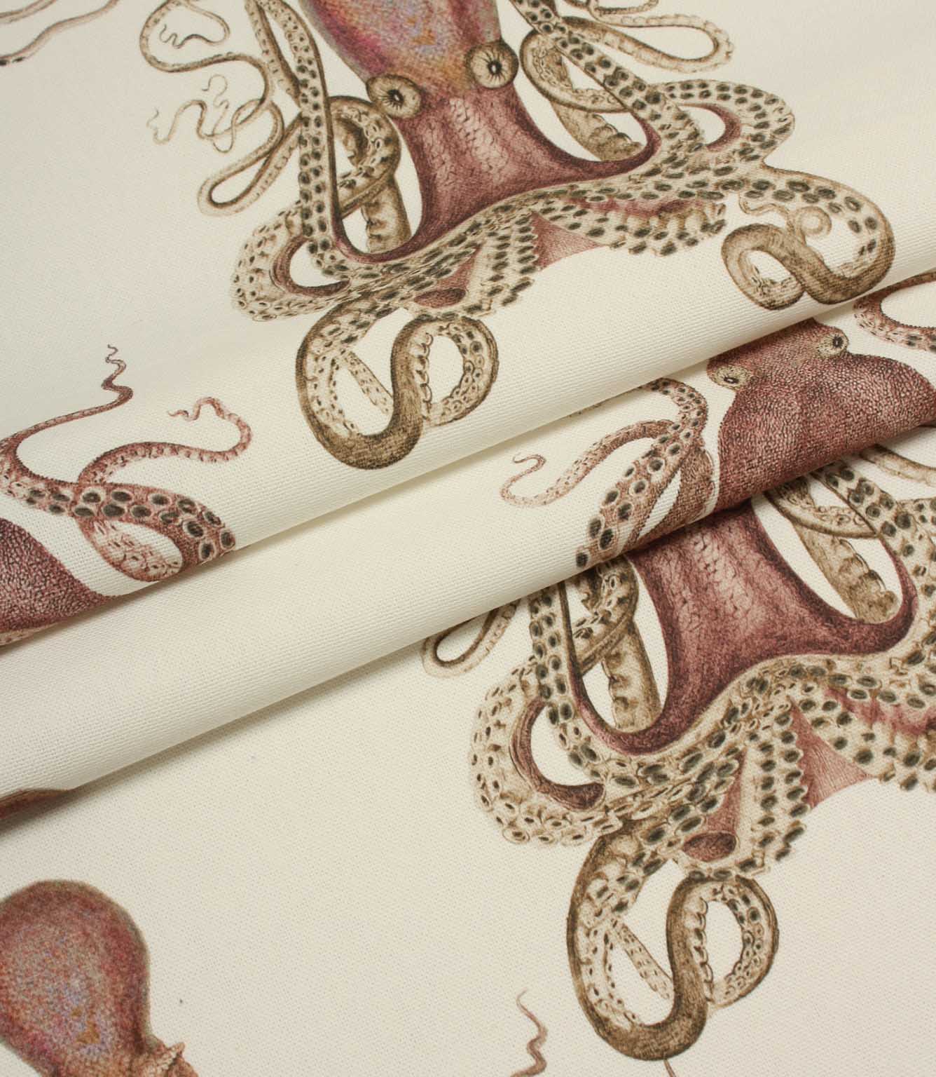 Folded fabric with orange octopus pattern on a cream background