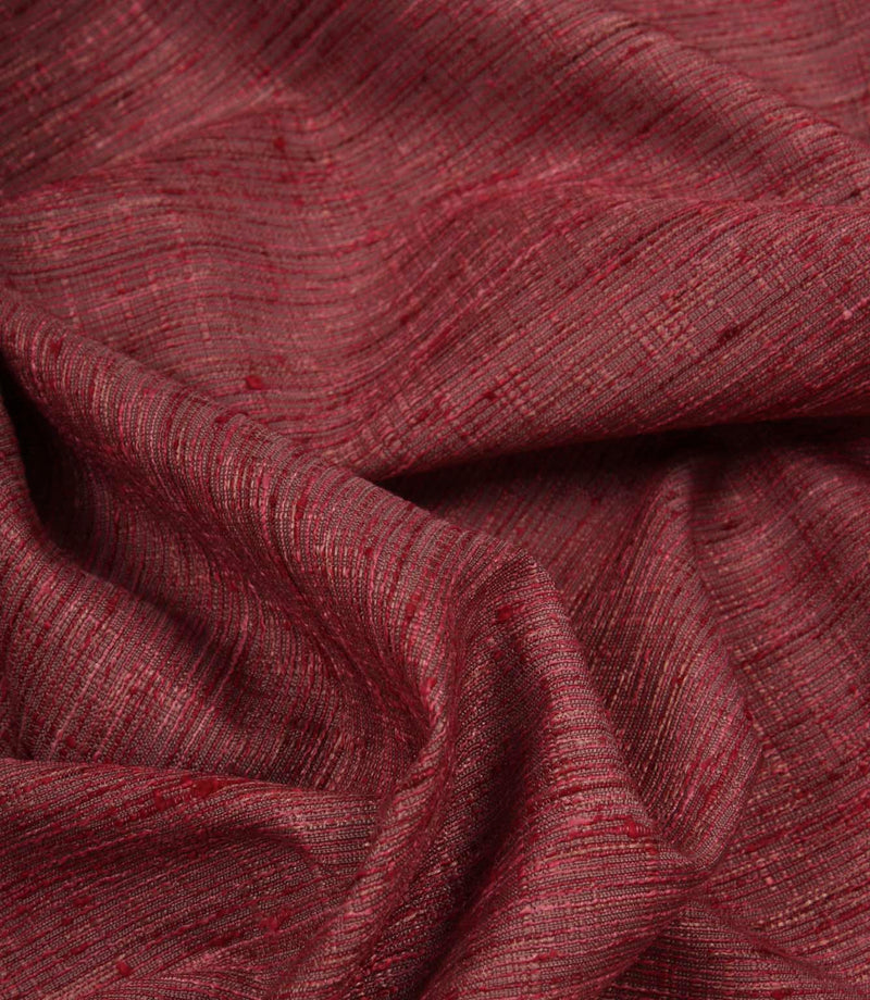 Otaru contemporary woven fabric draped in soft folds, displaying its texture and elegant movement in a red and pink shade.