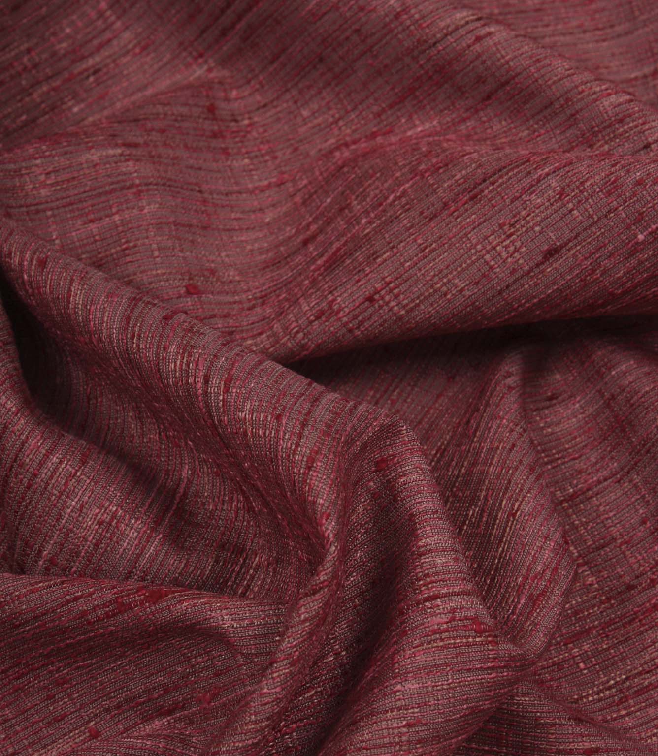 Otaru contemporary woven fabric draped in soft folds, displaying its texture and elegant movement in a red and pink shade.