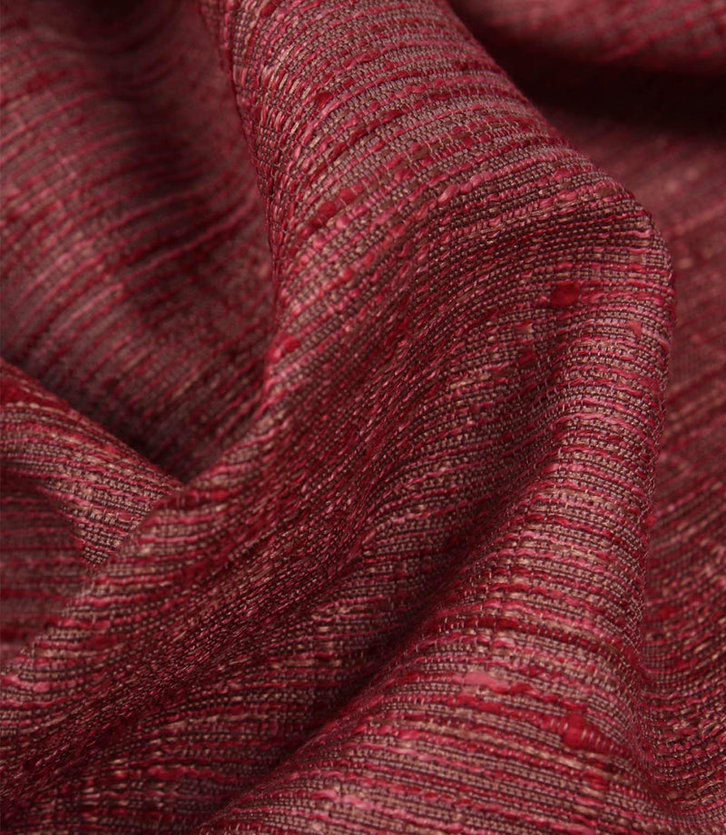 Close-up of Otaru woven fabric in red and pink, highlighting the tactile weave and subtle tonal variation.
