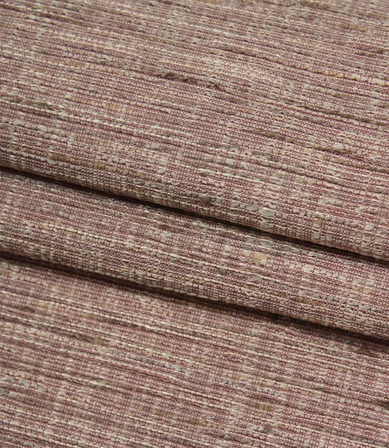 Folded Otaru woven fabric in a blush pink shade, displaying the fabric's textured weave and natural depth.