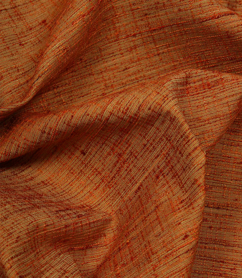 Otaru contemporary woven fabric in sunset orange draped in soft folds, demonstrating its elegant movement and tactile texture.