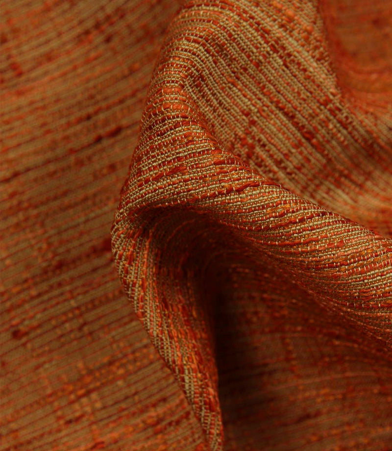 Detailed close-up of Otaru woven plain fabric in sunset orange, featuring the intricate weave, textured yarns and dimensional surface finish.