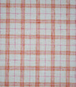 Painswick Check Russett fabric featuring a classic woven check pattern with warm russet orange and soft pink intersecting stripes on a natural cream background, creating a traditional country-inspired design.