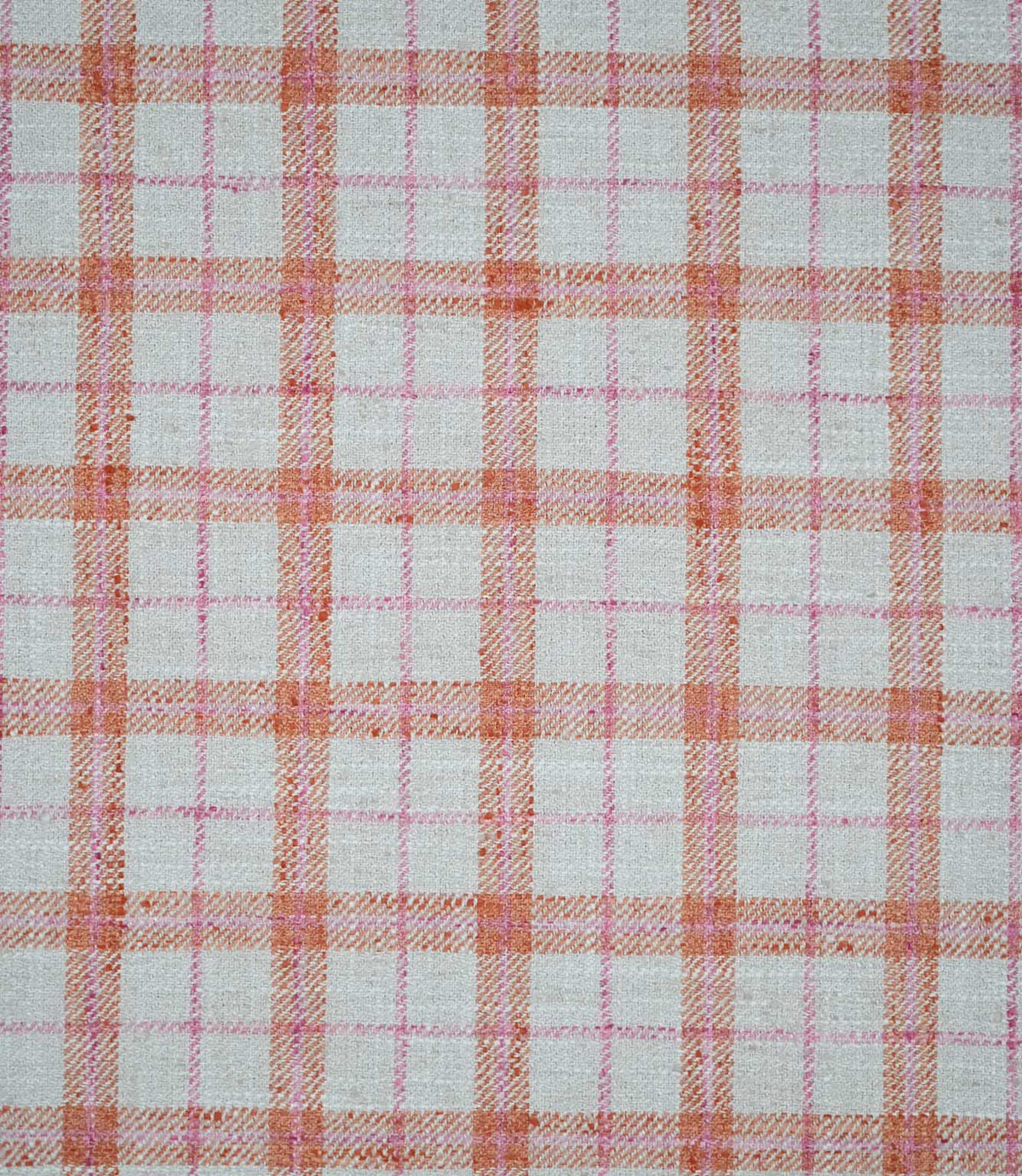 Painswick Check Russett fabric featuring a classic woven check pattern with warm russet orange and soft pink intersecting stripes on a natural cream background, creating a traditional country-inspired design.