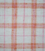 Close-up of Painswick Check Russett fabric showing a detailed woven check design with textured russet orange bands, delicate pink lines and a natural cream base, highlighting the interwoven yarns and subtle diagonal detailing.