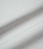 Palermo Marble fabric arranged in soft, flowing folds, showing its pale grey colour, gently textured surface and subtle variations in tone as the material catches the light.