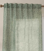 Close-up of Perrie Leaf sheer curtain in forest green and soft white, showing the gathered hidden tab top heading and small-scale leafy design.
