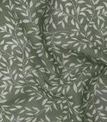 Detailed close-up of Perrie Leaf sheer fabric in forest green and soft white, showing the fine woven texture and repeating botanical leaf design.