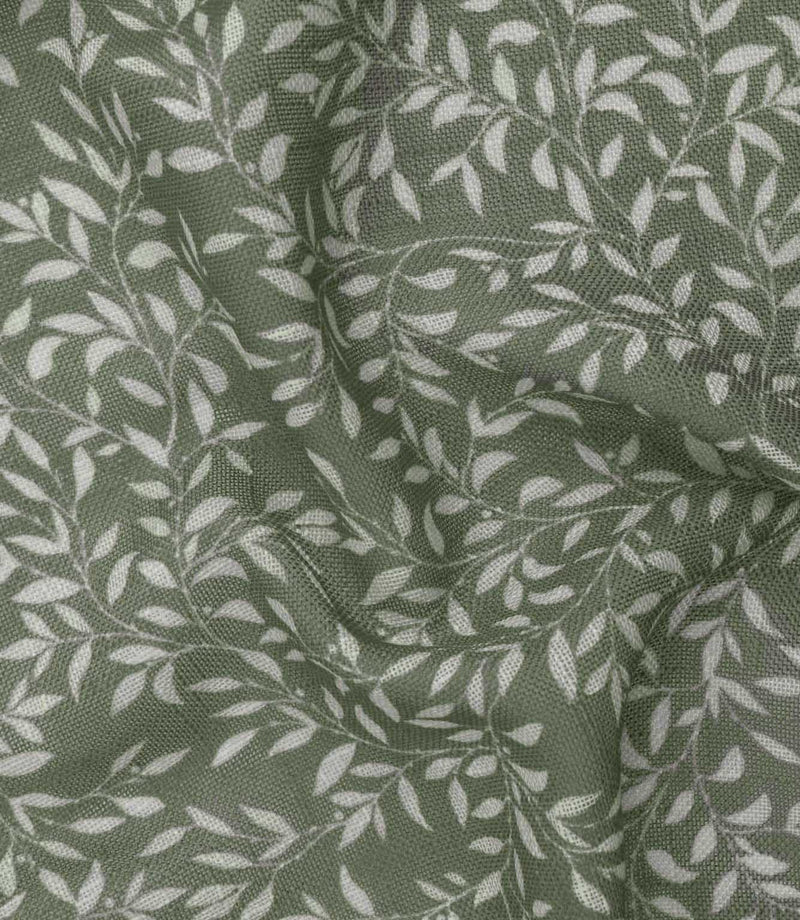 Detailed close-up of Perrie Leaf sheer fabric in forest green and soft white, showing the fine woven texture and repeating botanical leaf design.