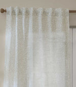 Close-up of Perrie Leaf sheer curtain in natural cream and beige, showing the gathered heading, lightweight fabric and small-scale leafy pattern.