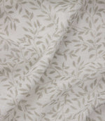 Detailed close-up of Perrie Leaf sheer fabric in natural cream and beige, showing the fine open weave and repeating trailing leaf design.