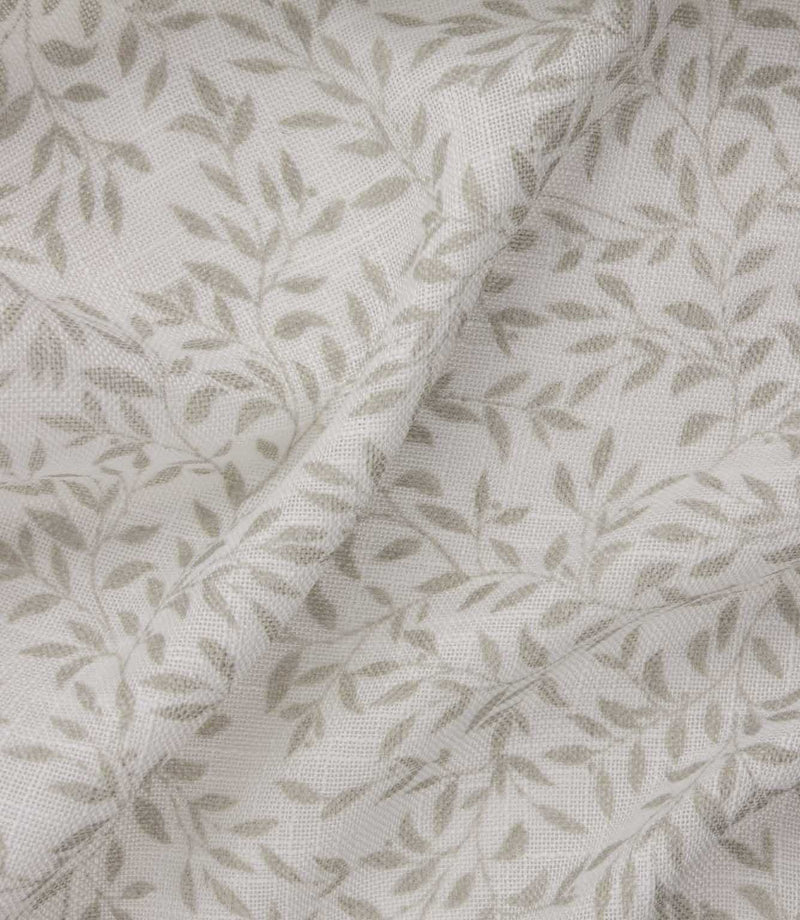 Detailed close-up of Perrie Leaf sheer fabric in natural cream and beige, showing the fine open weave and repeating trailing leaf design.