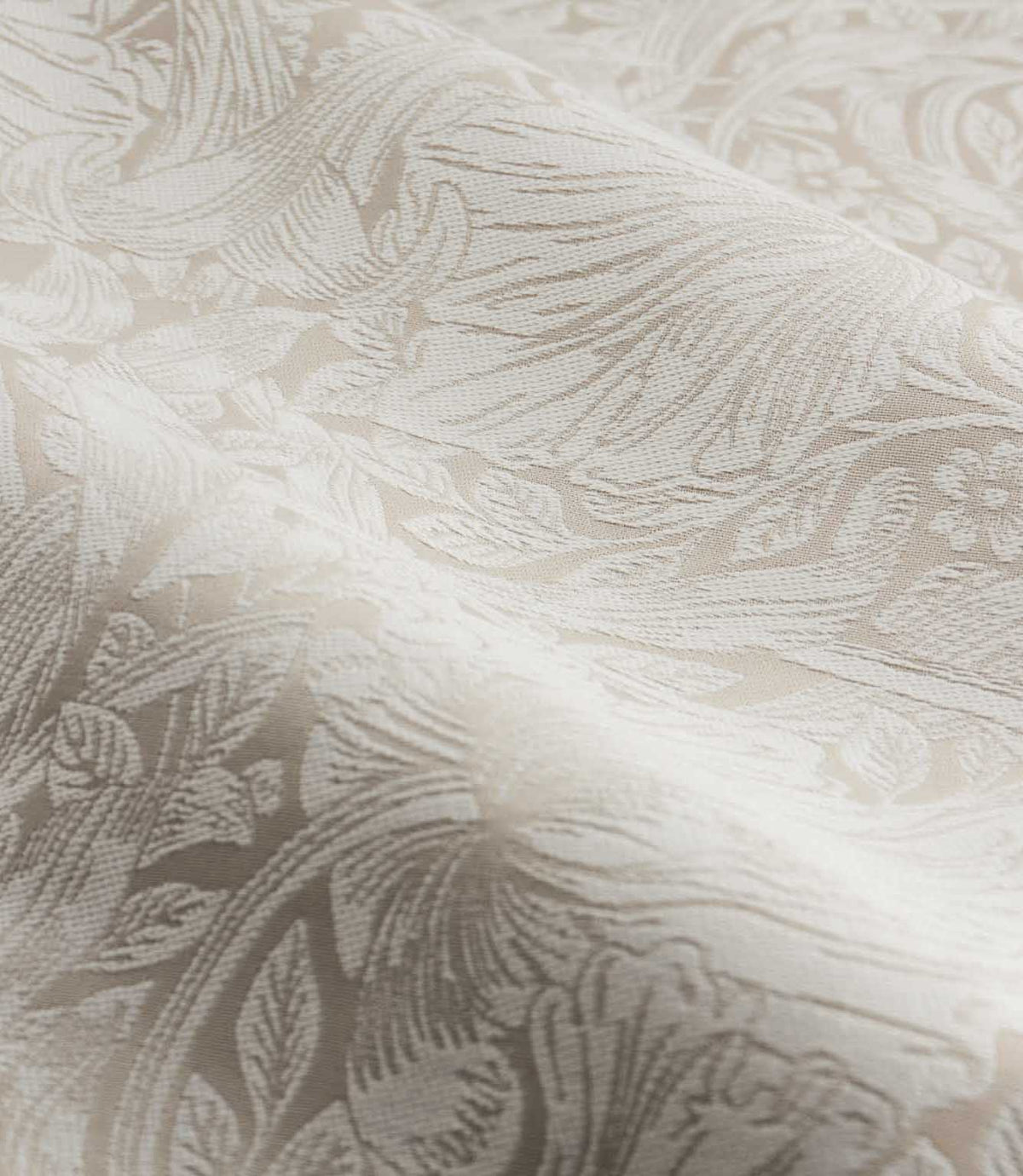Close-up of Morris & Co Pimpernel jacquard fabric in cream and beige, showing the textured weave and detailed William Morris floral and foliage pattern.