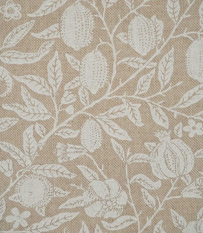 Close-up of Pomegranate Linen Look William Morris fabric in beige and cream, showing pomegranate fruits, leaves, flowers and the textured linen-look weave
