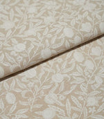 Folded Pomegranate Linen Look William Morris fabric in natural beige and cream, showing the pomegranate and leafy floral design across the linen-look surface.