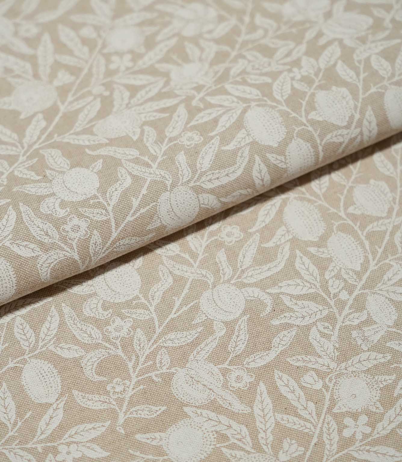 Folded Pomegranate Linen Look William Morris fabric in natural beige and cream, showing the pomegranate and leafy floral design across the linen-look surface.