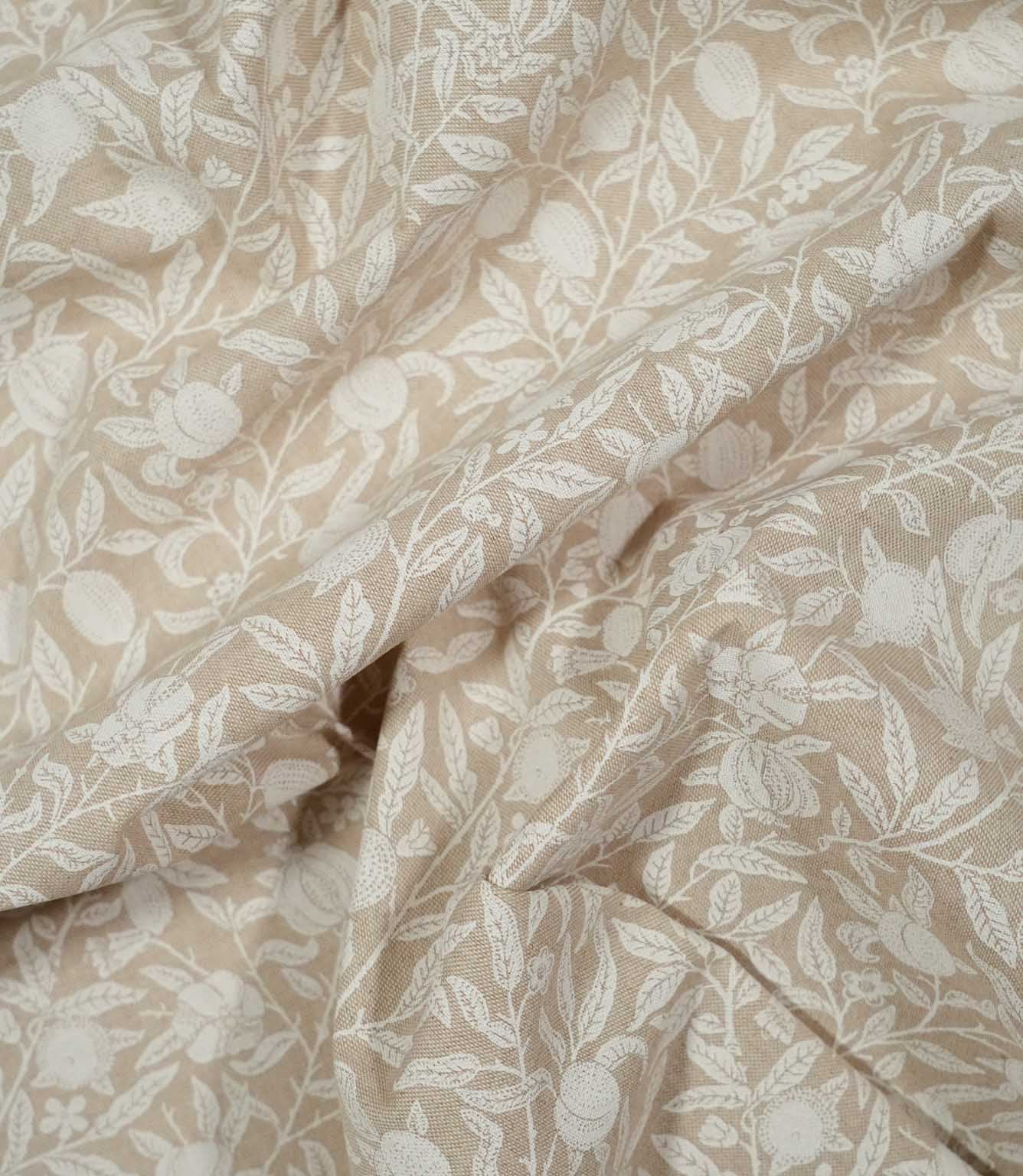 Draped Pomegranate Linen Look William Morris fabric in beige and cream, showing how the botanical design and linen-look texture appear in soft folds.